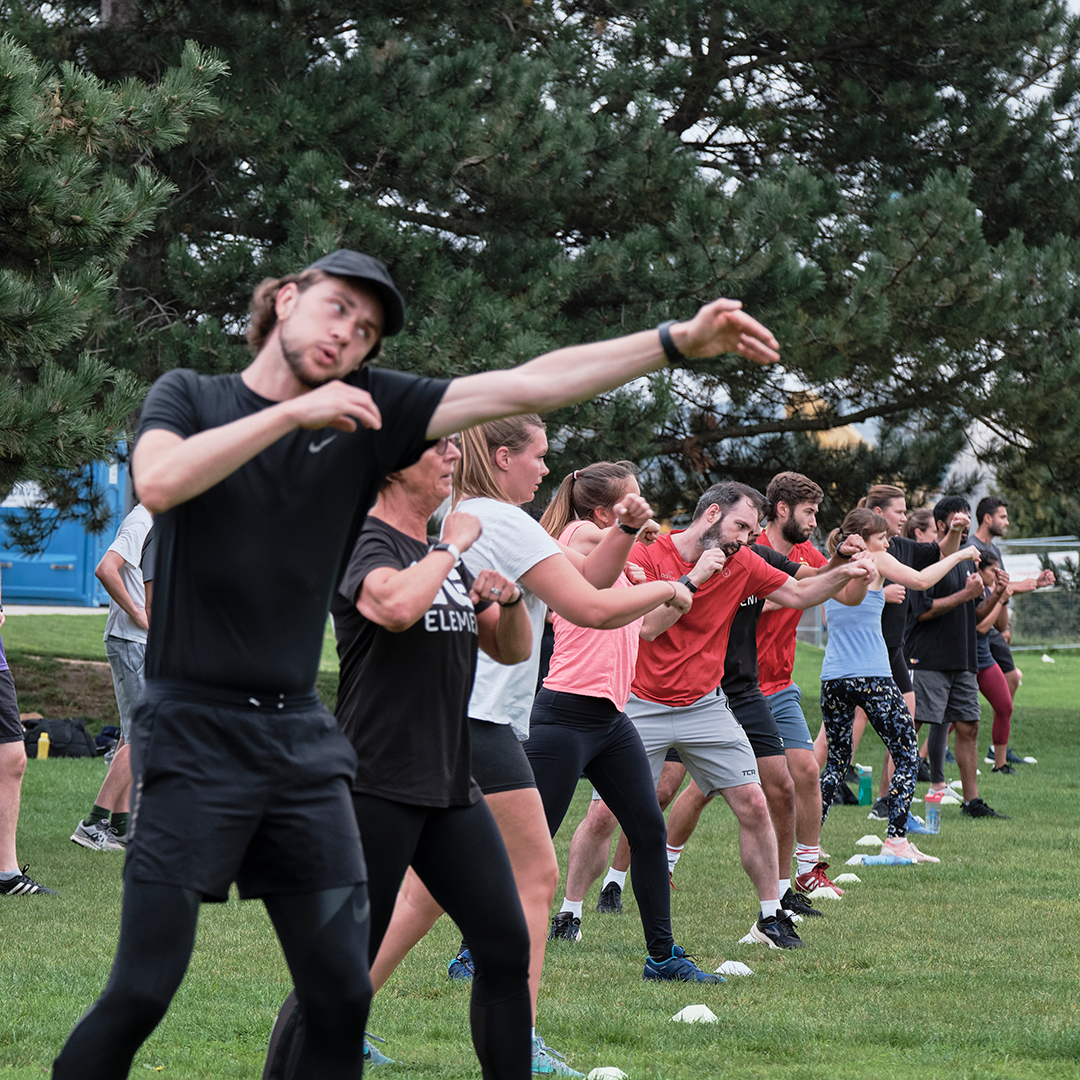 One Element members forming connection through group exercise.